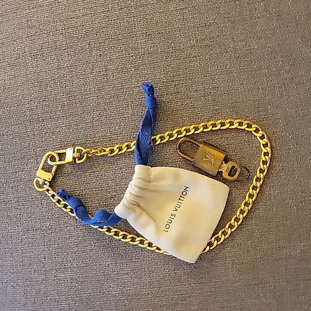 Louis Vuitton Lock, key, bag, and chain.